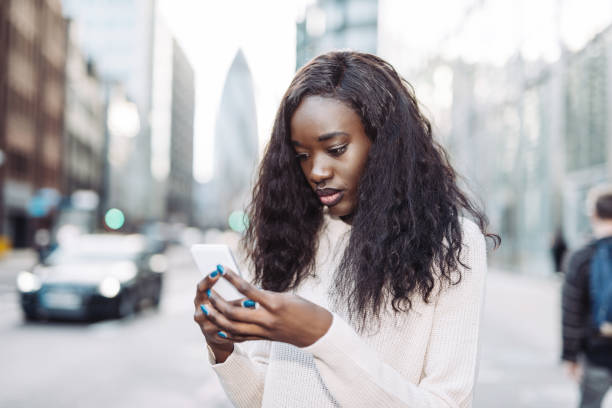 istock Young African woman sending text messages 937035068