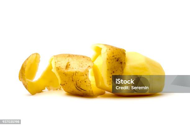 Peeled Potatoes On A White Background Raw Peeled Potatoes And Peelings Closeup Stock Photo - Download Image Now