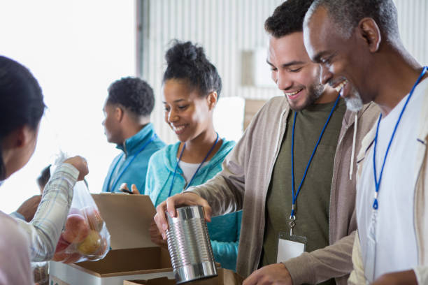istock Diverse men organize food during food drive 937035348