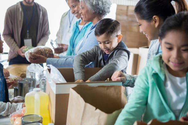 istock Mixed race boy helps out during food drive 937035356