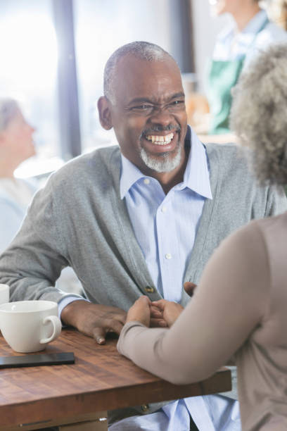 istock Senior man laughing while having coffee with wife 937037564