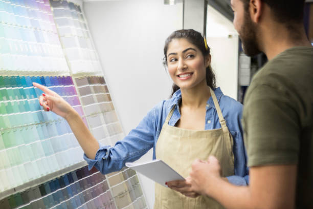 istock Cheerful hardware store employee working in paint department 937037730