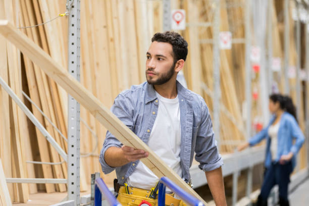istock Young man loads lumber in home improvement warehouse 937037754