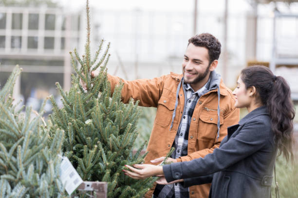 istock Happy couple shopping for Christmas tree 937037790