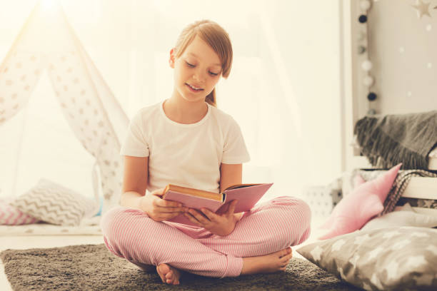 istock Smart pleasant girl reading an interesting story 937039096