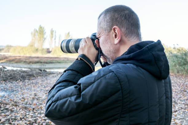 istock Photographer taking pictures in the park 937041400