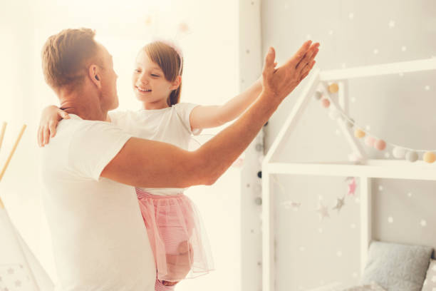 istock Cute happy girl dancing with her father 937042118