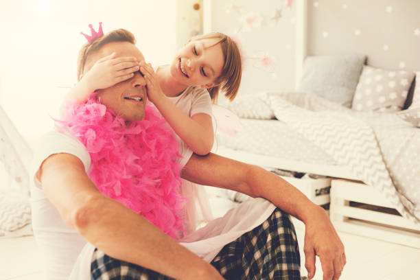 istock Nice cute girl covering her fathers eyes 937042240