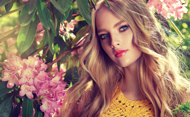 perfectly looking young woman is gazing on the viewer.  spring blossom and bloom of youth. symbol of blooming youth. - women beauty innocence make up imagens e fotografias de stock