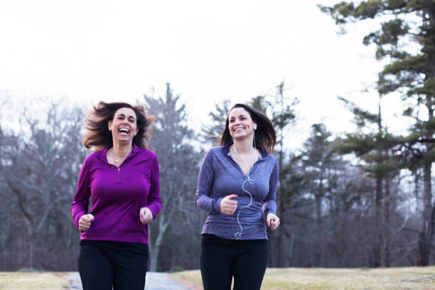 istock Mother and daughter jogging together for a workout 937048194