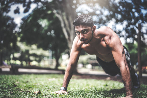 istock Fitness man doing push-ups at the outdoors park 937049498