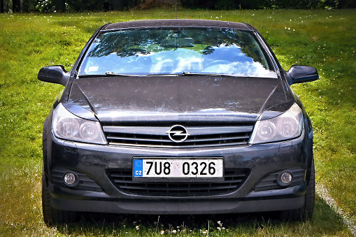 Dolni Adrspach, Czech republic - July 10, 2015: black car Opel Astra on improvizate grass parking lot for tourists