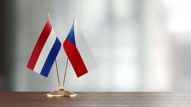 istock Dutch And Czechoslovakian Flag Pair On A Desk Over Defocused Background 937060038