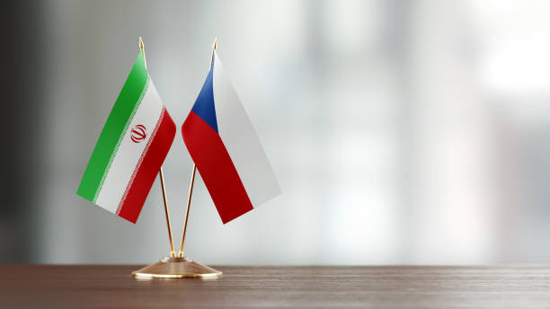 istock Iranian And Czechoslovakian Flag Pair On A Desk Over Defocused Background 937060454