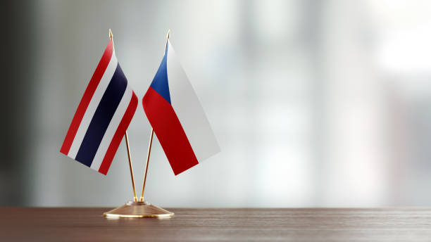 istock Thai And Czechoslovakian Flag Pair On A Desk Over Defocused Background 937060878
