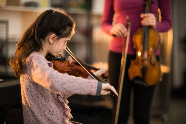 istock Teacher and student playing musical instrument 937061368