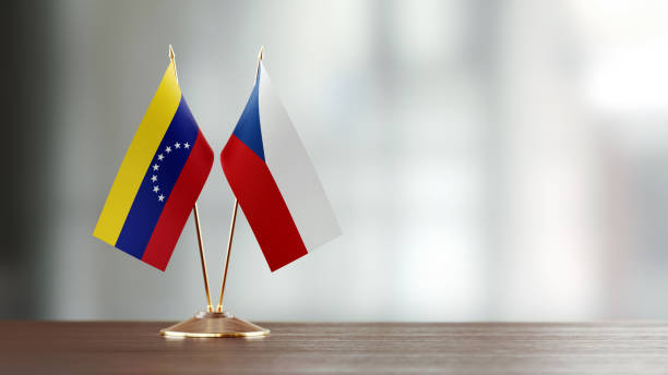 istock Venezuelan And Czechoslovakian Flag Pair On A Desk Over Defocused Background 937063932