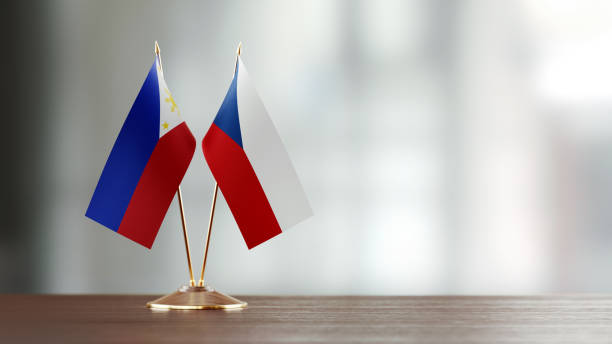 istock Philippines And Czechoslovakian Flag Pair On A Desk Over Defocused Background 937064032