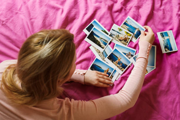 istock Browsing vacation photographs at home 937064076