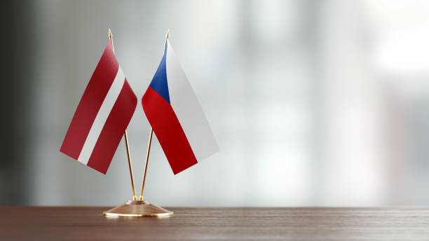 istock Latvian And Czechoslovakian Flag Pair On A Desk Over Defocused Background 937064254
