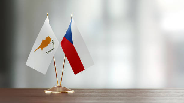 istock Cypriot And Czechoslovakian Flag Pair On A Desk Over Defocused Background 937064596