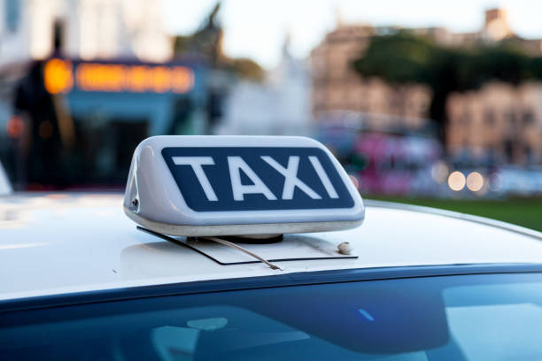 Close-up on a Taxi sign on the top of a Roman taxi.