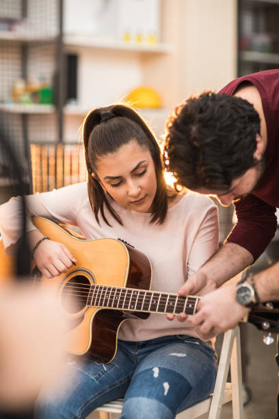 istock Young woman learning to play the guitar 937070008