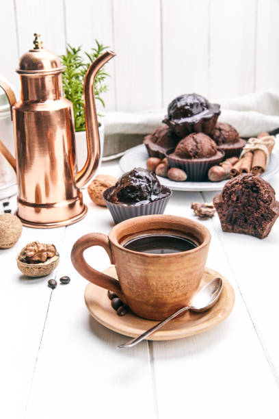 istock Coffee in clay cup with chocolate muffin 937073618