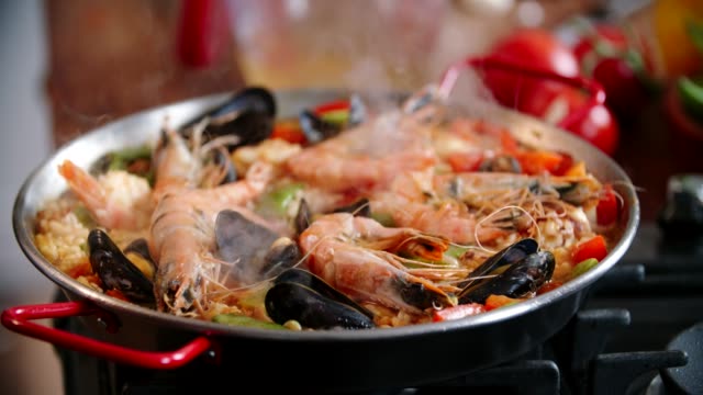 Preparing Seafood Paella with Shrimps, Squid, Mussels, Green Beans and Paprika