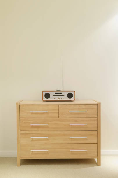 istock Neutral interior with retro cd music radio player on oak pine chest 937082112