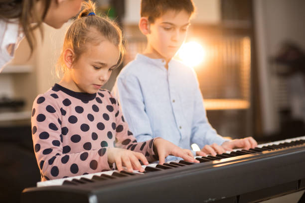 istock Playing piano in music school 937092236