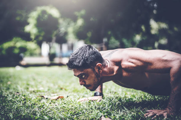 istock Fitness man doing push-ups at the outdoors park 937095596