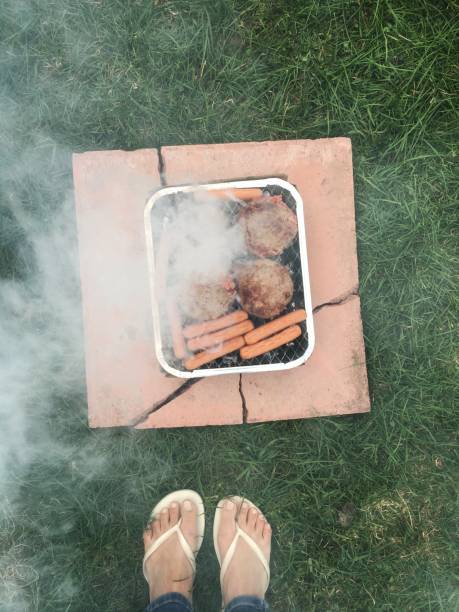 istock Preparing camping food on single use barbecue grill, England 937099324