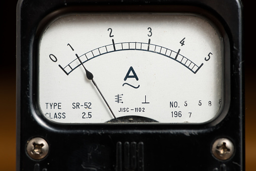 Details of an old black analog ampere meter, scale and indicator