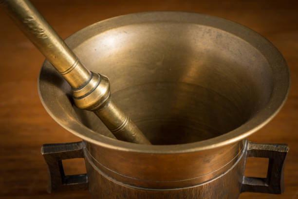 Mortar made of brass standing on a brown wooden table