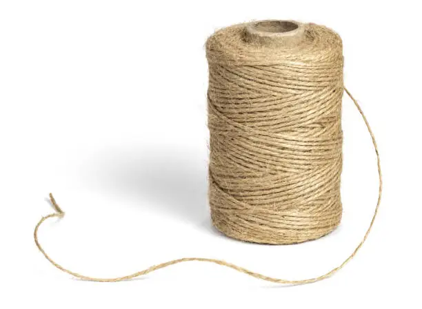 Coil of jute rope for packing, isolated on a white background.