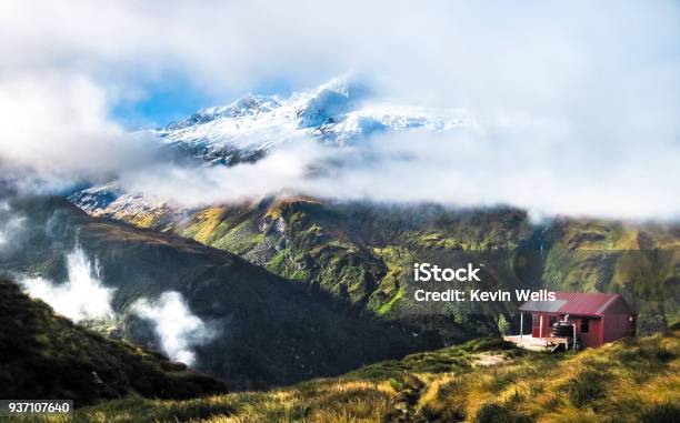 Rob Roy Peak Is Seen Through The Clouds With A Backcountry Hut Up Close New Zealand Stock Photo - Download Image Now