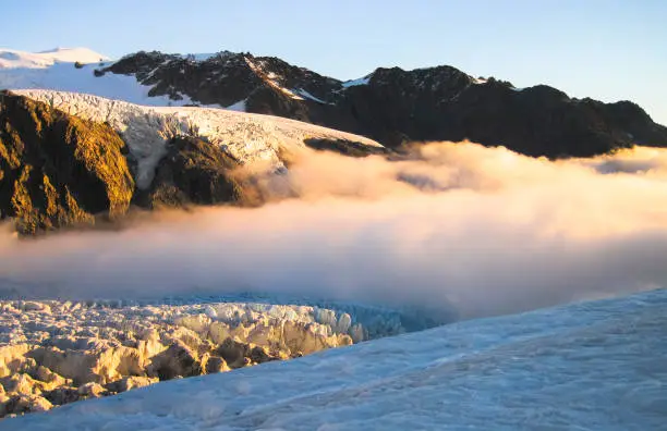 Photo of Clouds Roll in Over the Fox Glacier at Sunset in New Zealand