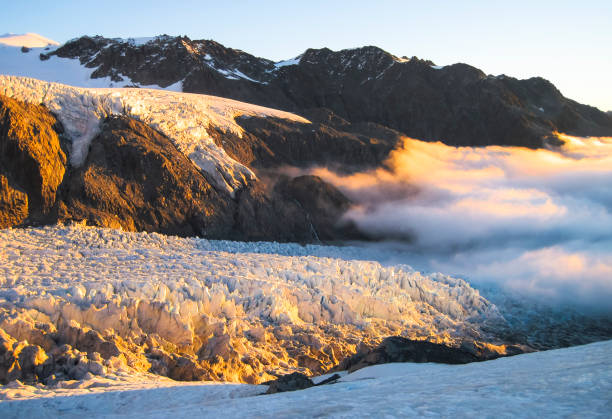 Photo of Clouds Roll in Over the Fox Glacier at Sunset in New Zealand