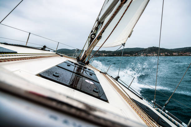 istock Sailing Boat Hitting a Wave on Rippled Sea 937111822