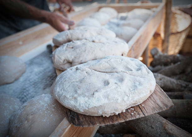 istock Bread dough in the foreground with bakery background 937114560