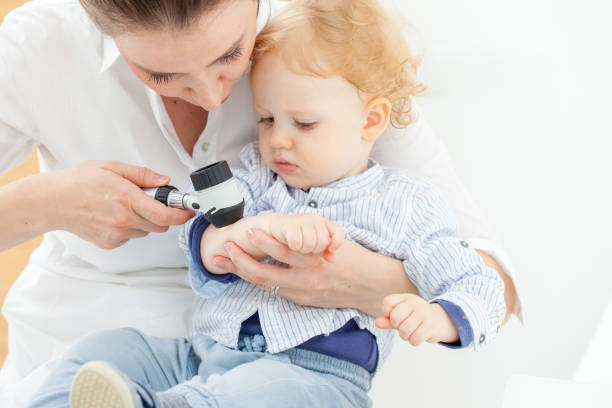 Baby Boy at Dermatologist for Mole Check-up stock photo
