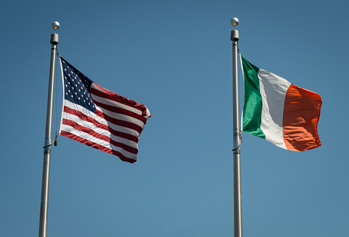 The Irish and American flags fly together.