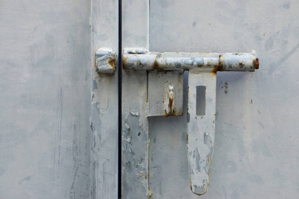 Old rusty iron lock on an old metal door