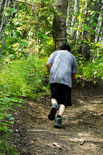 istock A young boy cross country running uphill 937130730
