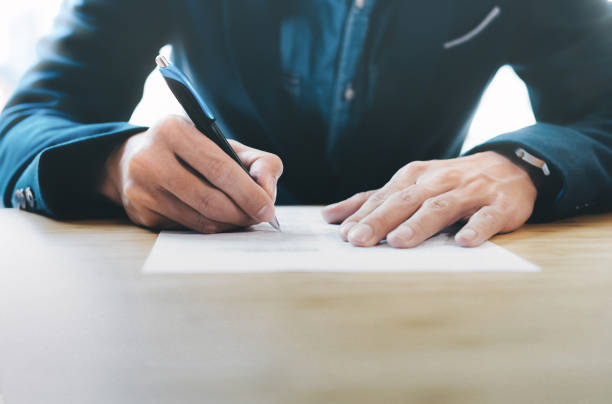 Businessman signing contract making a deal. stock photo