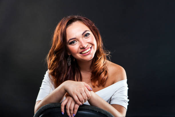 Pretty young girl on black background in studio stock photo