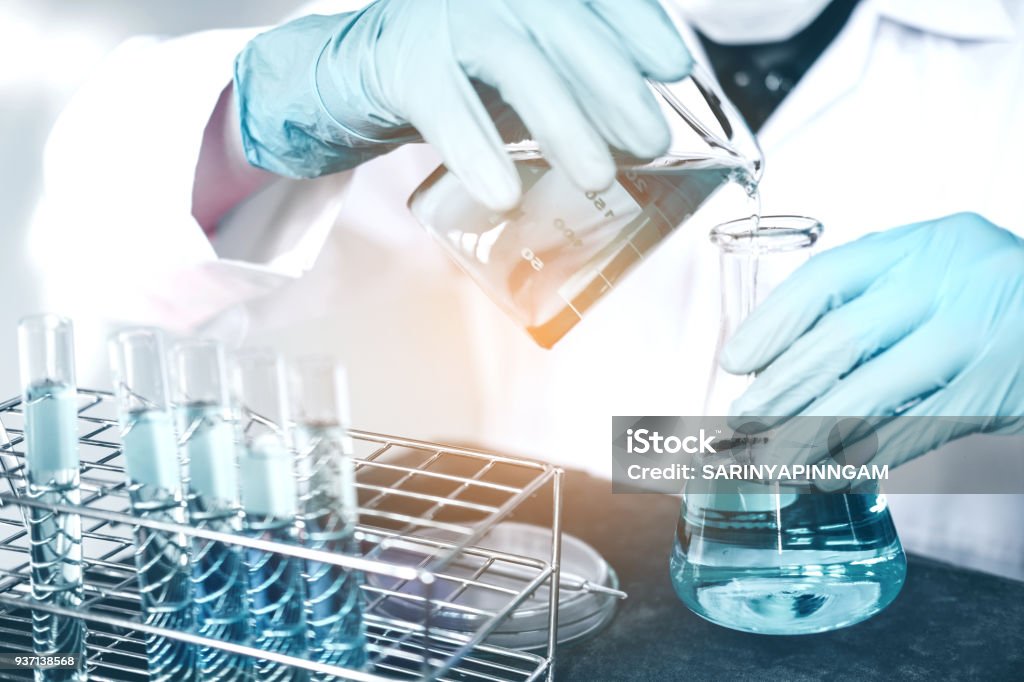 Scientist with equipment holding tools during scientific experiment science concept Water Stock Photo