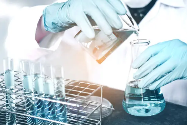 Photo of Scientist with equipment holding tools during scientific experiment science concept