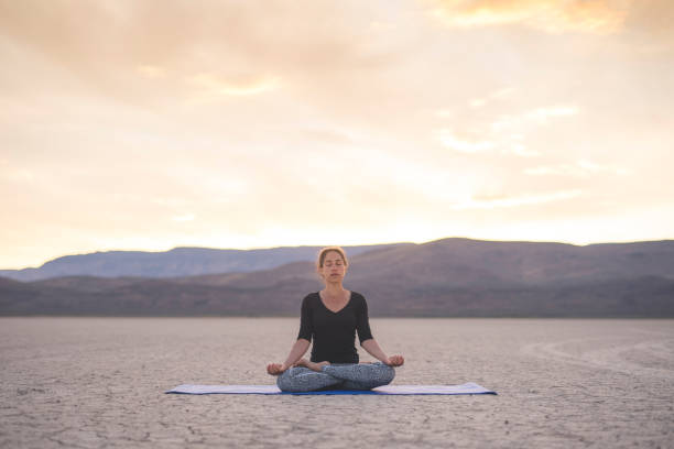 istock Ethnic woman doing yoga in the desert 937144320